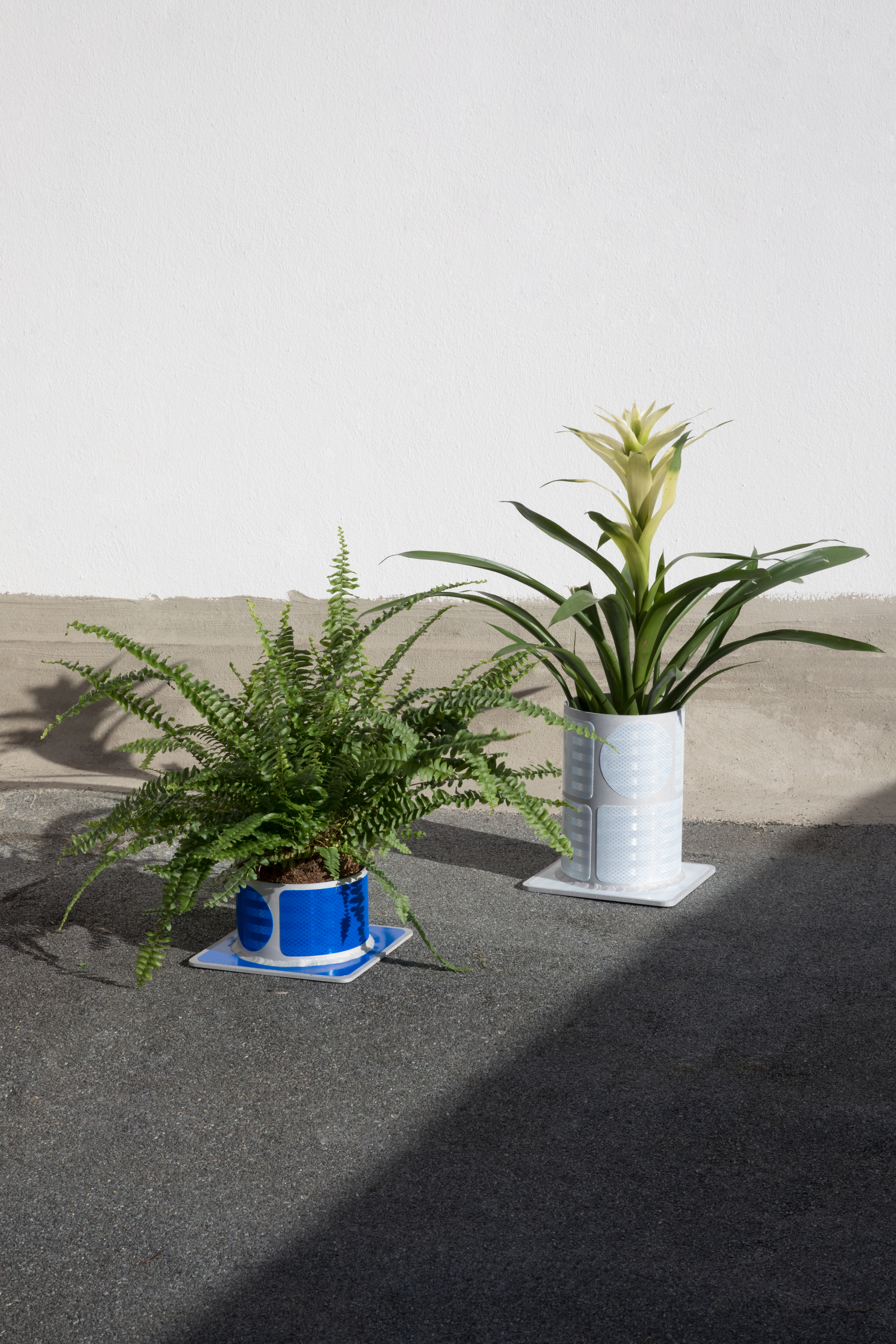 Oliver-Selim Boualam, *Kriegstraße, reflector vase prototype 1 and 2*, sandblasted aluminum, micro prismatic reflective foil, 9×20×20cm & 22×20×20cm